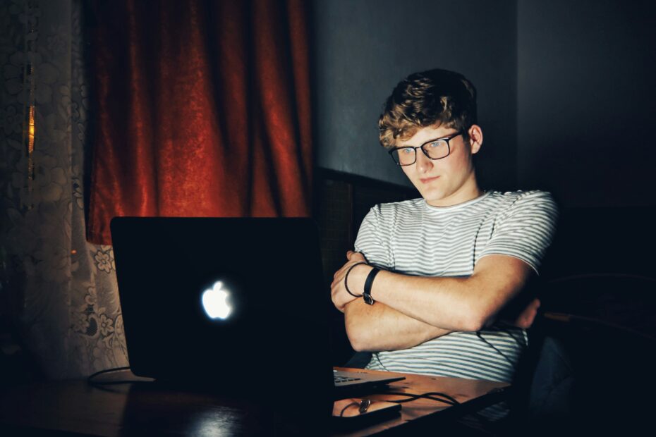 Person browsing escort sites online at night