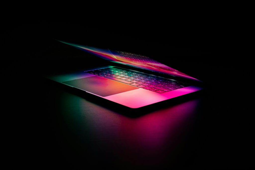 Laptop glowing in a dark room