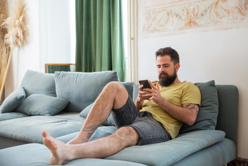 Man browsing websites on his phone at home