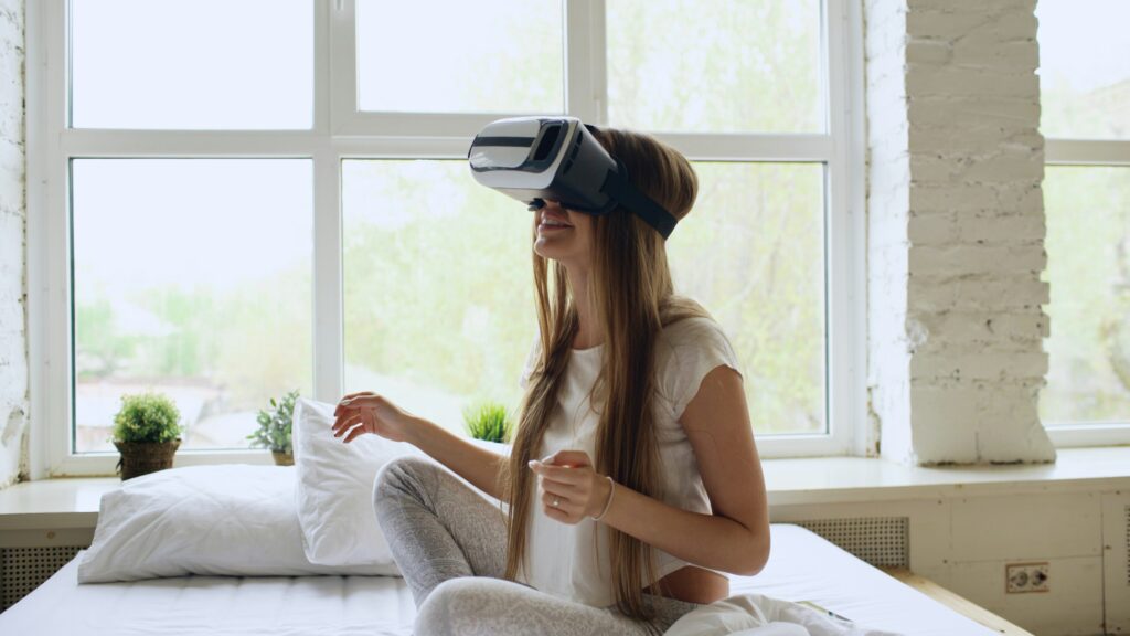 Woman using a VR headset in bed