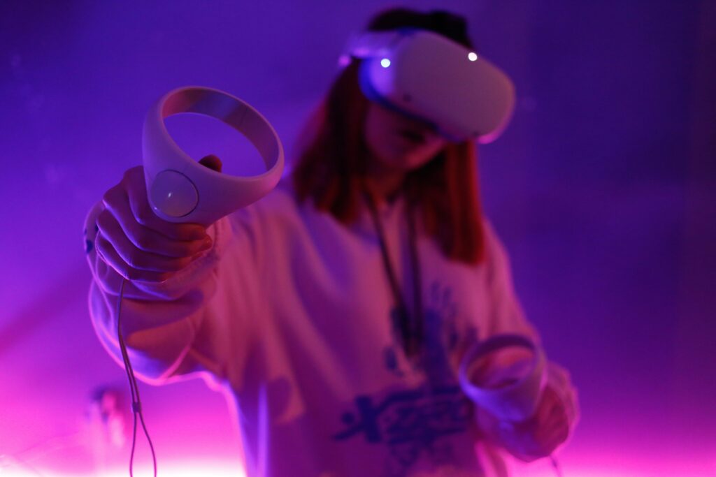 Person using a VR headset in a neon lit room