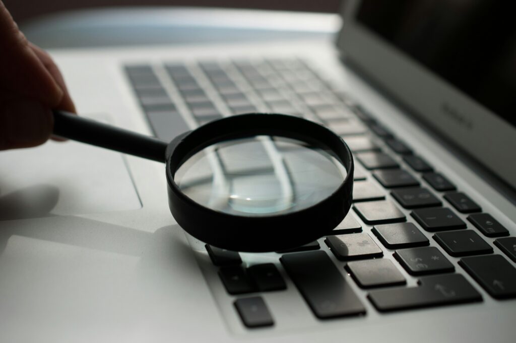 Magnifying glass placed over a computer keyboard